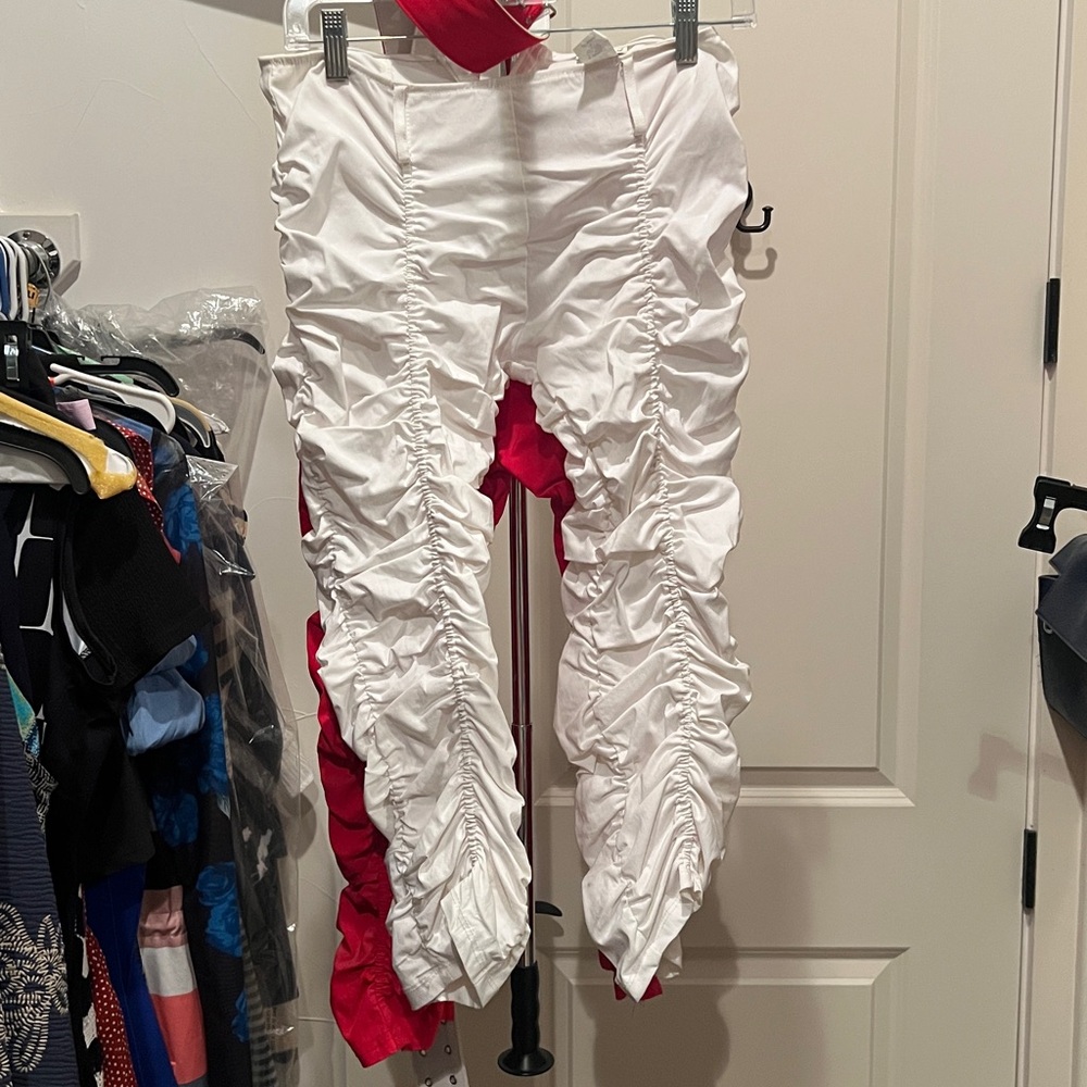 1 red and 1 white. Both come with matching belt. Zipper is in the back.